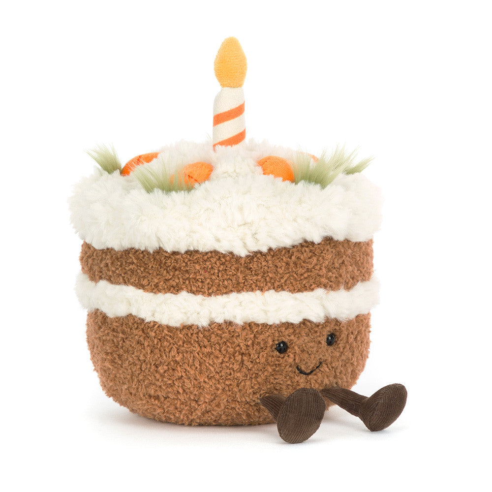 Amusables Carrot Cake by JellyCat featuring a cute plush design with a smiling face, fluffy frosting, and a decorative candle on top.