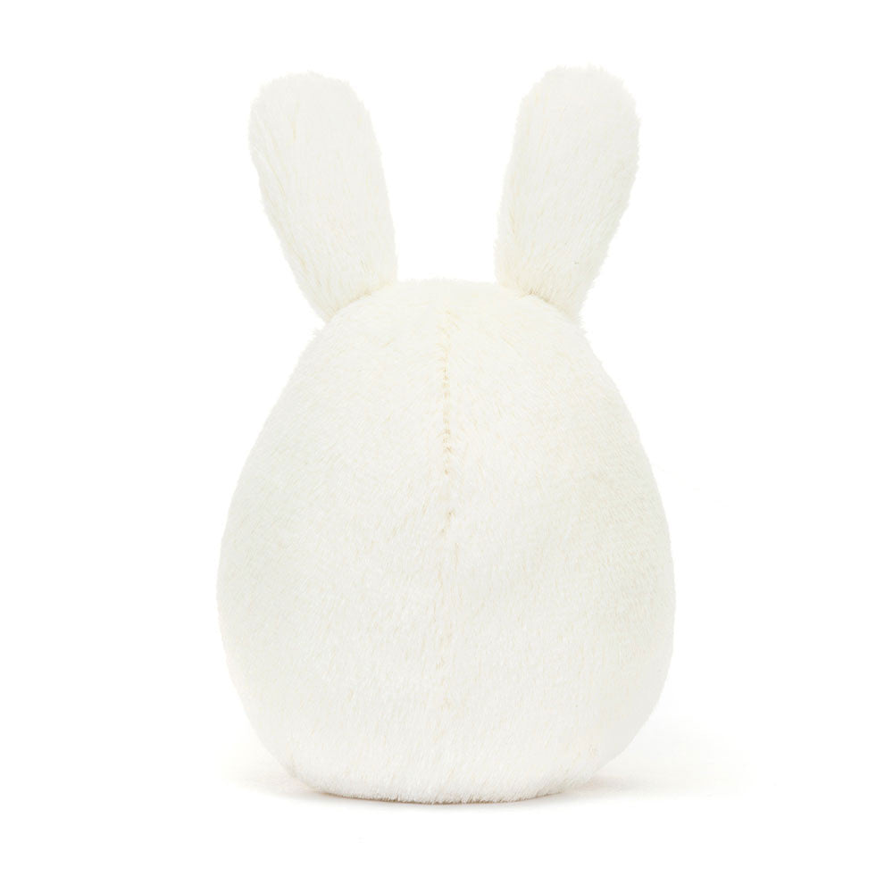 Back view of the JellyCat Amuseables Bunny Egg Plush, showcasing its fluffy white texture and floppy ears, ideal for spring-themed decor and as a delightful Easter plush toy.