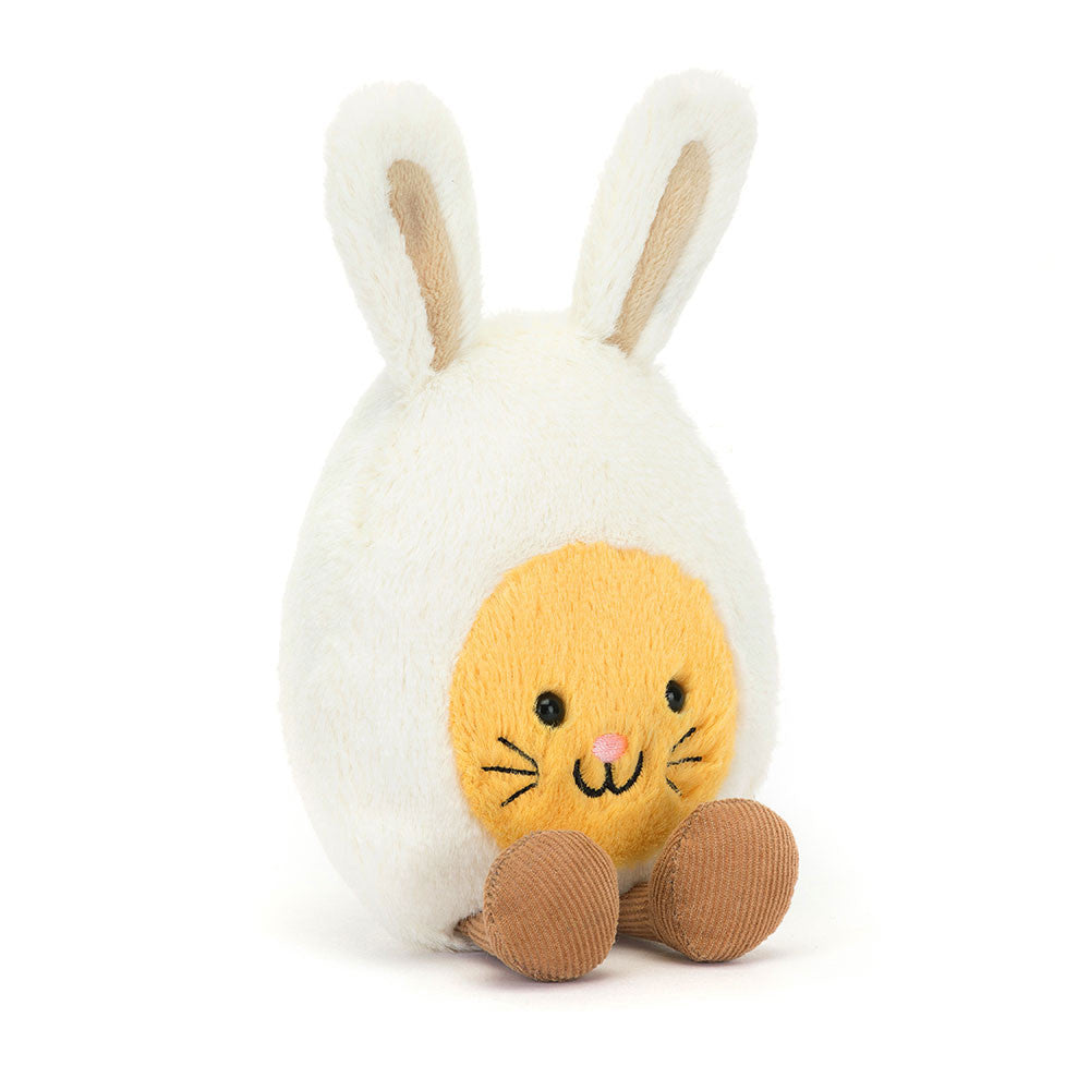 The JellyCat Amuseables Bunny Egg Plush sitting upright, displaying its adorable features and soft texture, making it a perfect companion for kids during Easter and egg hunts.