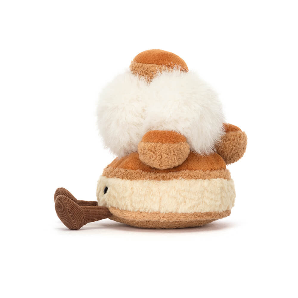 Side view of the playful Amuseables Mirielle St. Honoré plush by JellyCat, highlighting its fluffy cream topping and cozy design.