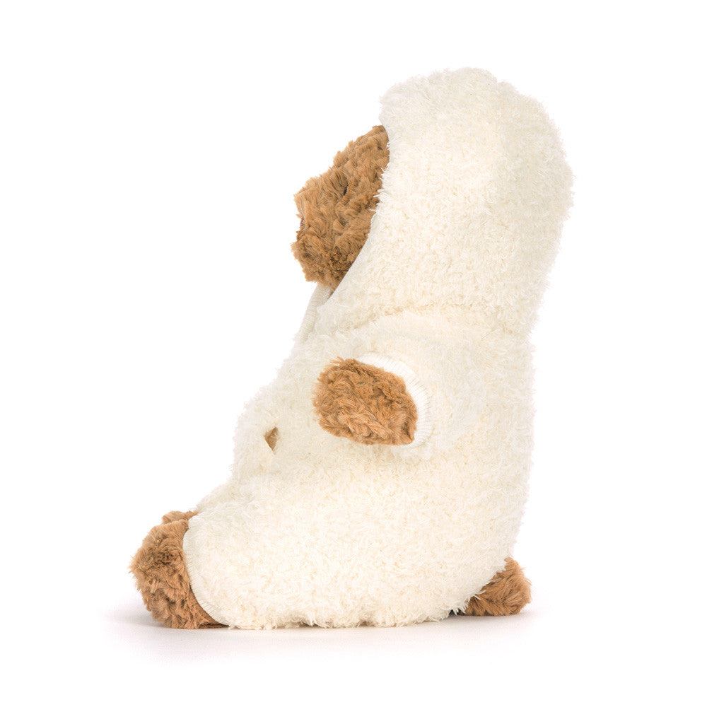 Side view of Bartholomew Bear All-in-one Outfit by JellyCat, displaying the plush bear dressed in a soft white outfit, highlighting its adorable features.
