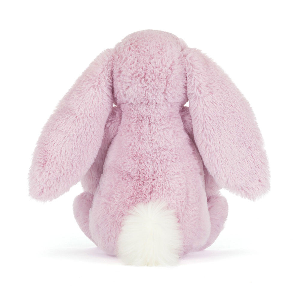 Back view of Thistlepop Blossom Luxe Bunny by JellyCat, showcasing its fluffy pink fur and cute tail.
