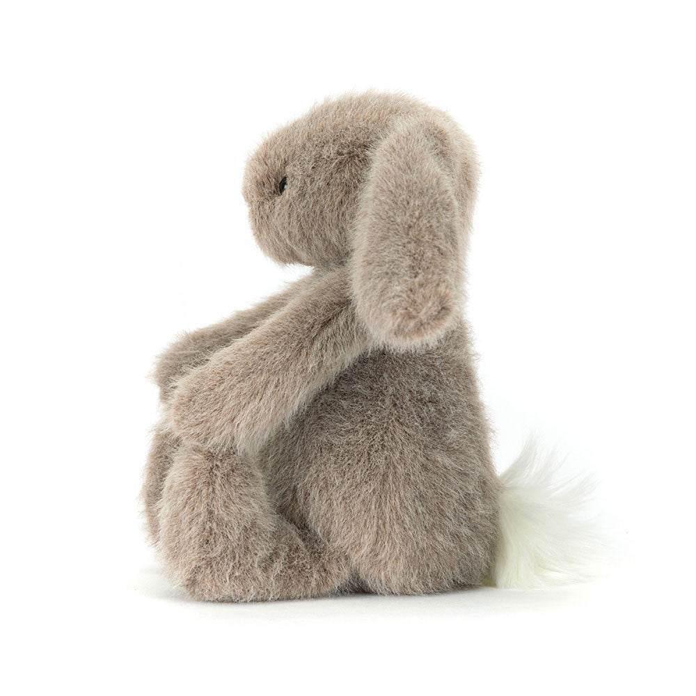 Side view of the Fawn Flufflet Bunny by JellyCat, showcasing its adorable design and cuddly stature.