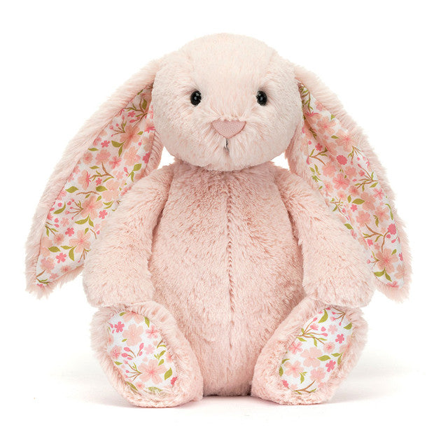 Blossom Blush Bunny by JellyCat, a cute plush toy in blush-pink with floral ears, sitting softly with its cream bobtail.