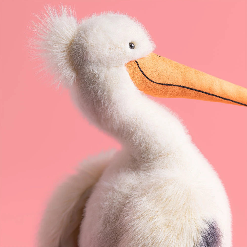 Keli Pelican SS26 plush toy featured in a playful setting, inspiring seaside adventures.