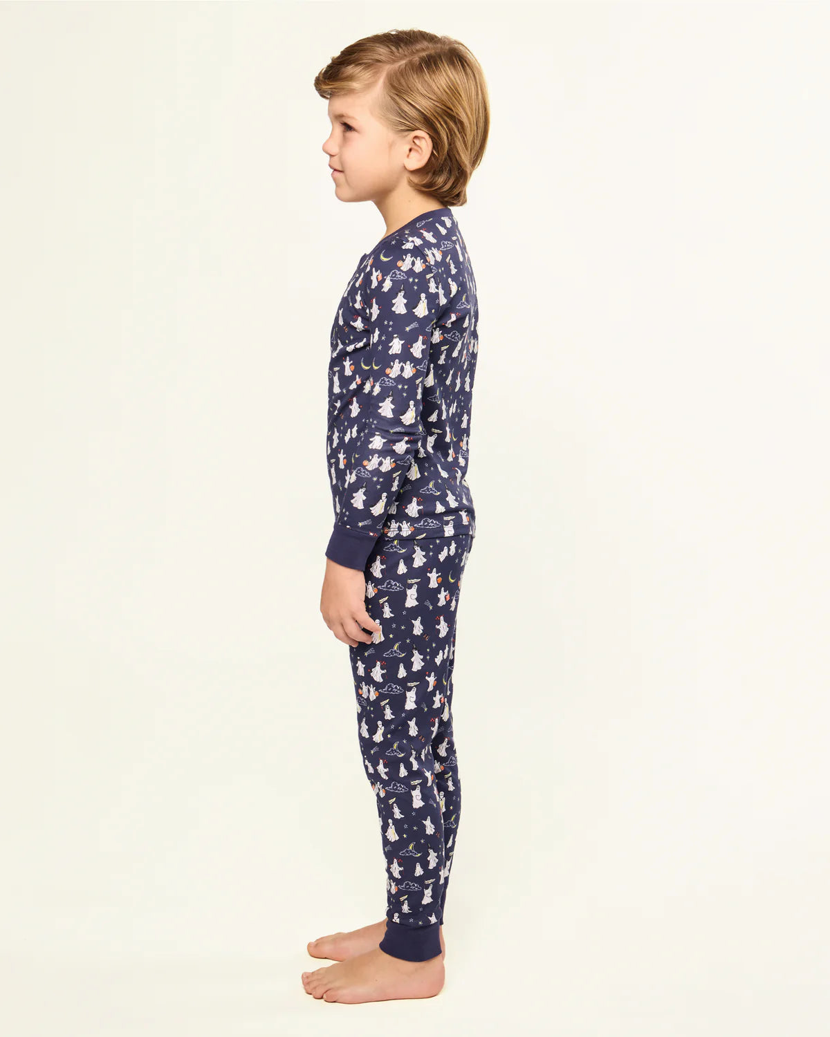 Side profile of a child in the Kids Pima Snug Fit Pajama in Spooky Slumber by Petite Plume, highlighting the snug fit and Halloween theme.