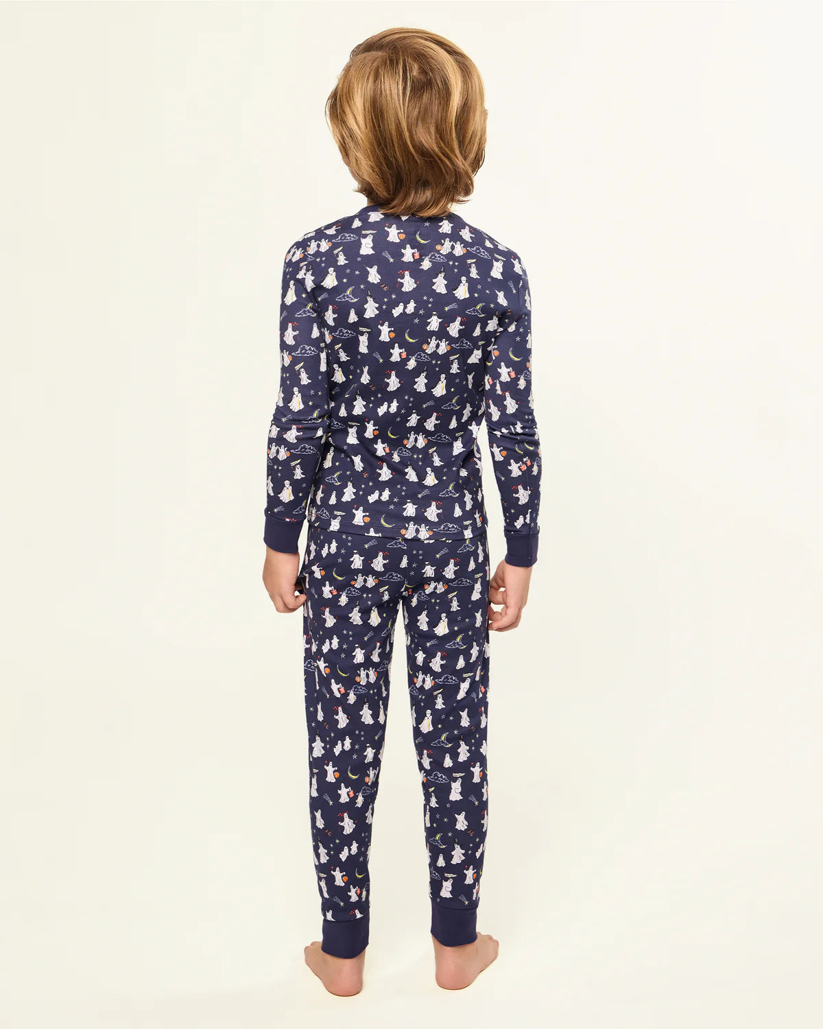 Back view of a child wearing the Kids Pima Snug Fit Pajama in Spooky Slumber by Petite Plume, showcasing the cute ghost designs.