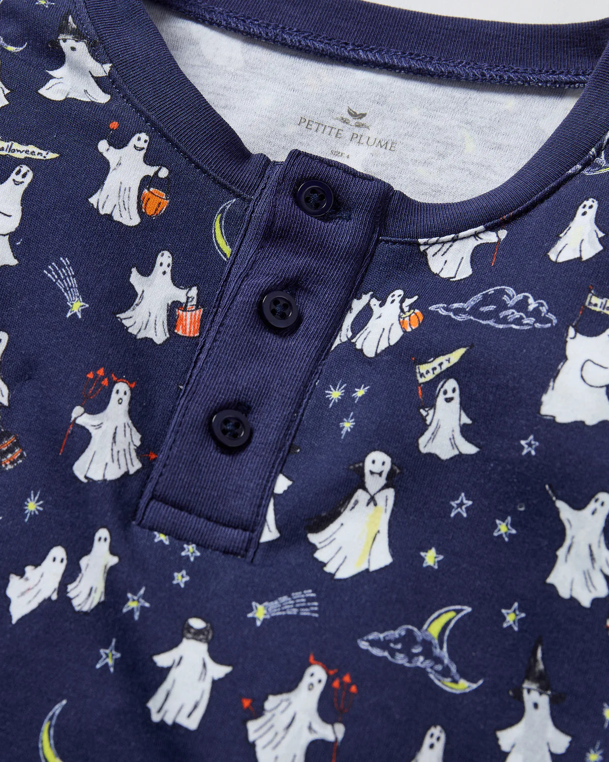 Close-up of the Kids Pima Snug Fit Pajama in Spooky Slumber by Petite Plume, showing the button detail and vibrant ghost print.