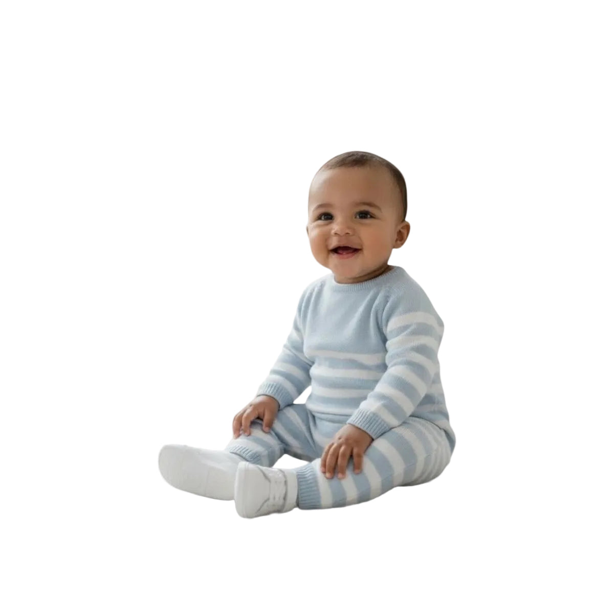 A smiling baby sitting cross-legged wearing a light blue and white striped knit romper against a solid off-white background.
