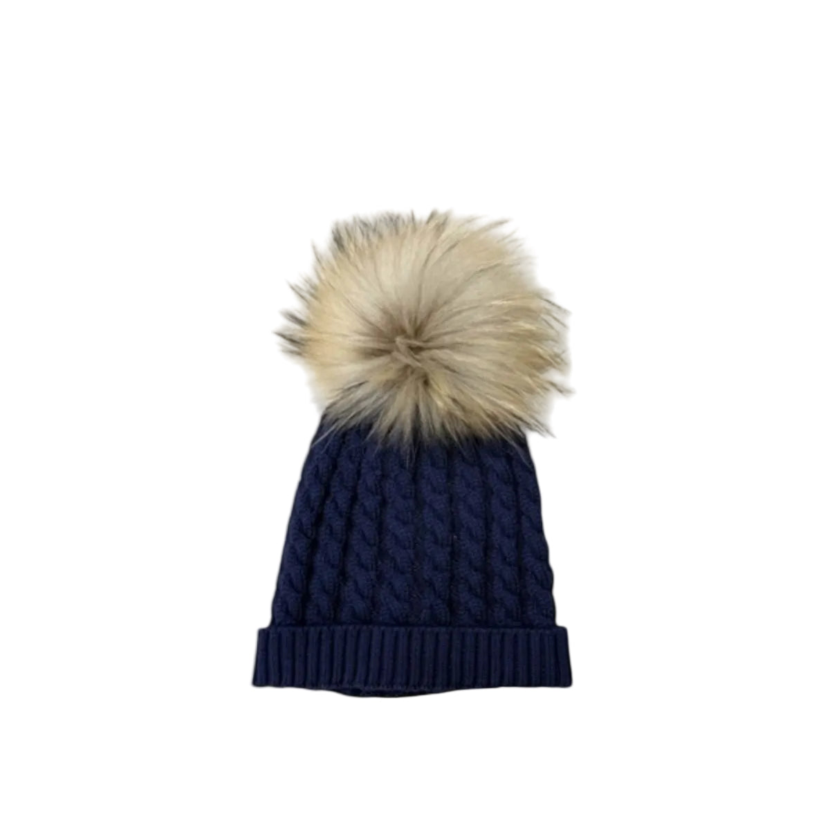 A navy blue cable-knit beanie hat with a large, fluffy beige faux-fur pom-pom on top, displayed against a clean off-white background.