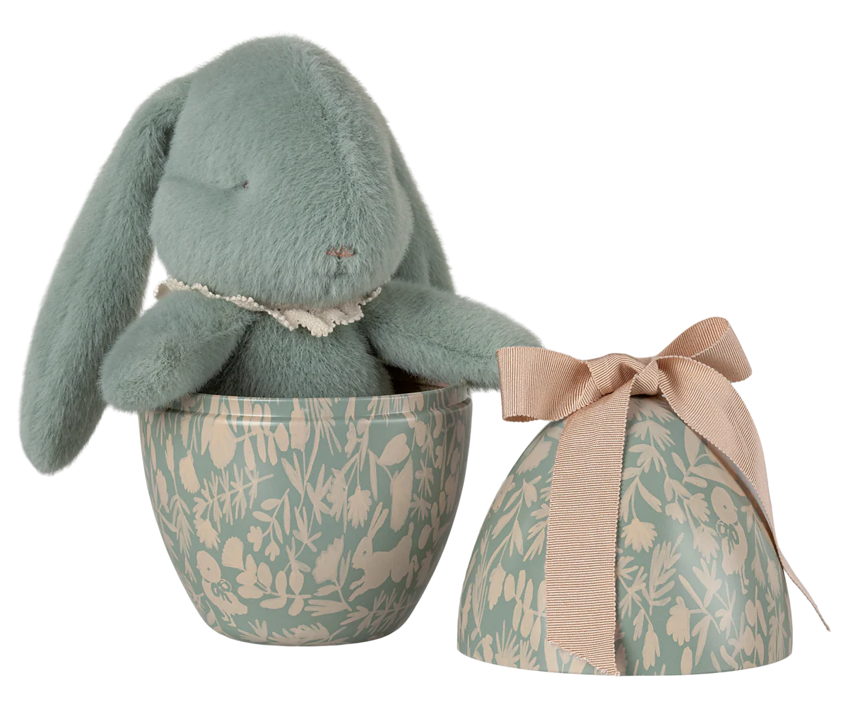 Cute mint plush bunny with a vintage cotton collar resting inside a decorative metal egg, featuring a beautiful floral print and a ribbon bow, perfect for Easter celebrations. By Maileg, this vintage easter decoration adds charm to any festive setting.