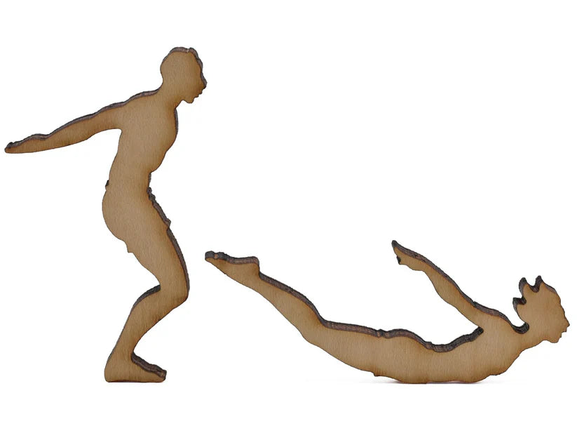 Two whimsical wooden puzzle pieces representing a playful scene of a person diving into the water, featured in the 'Summer at the Lake' puzzle by Liberty Puzzles.