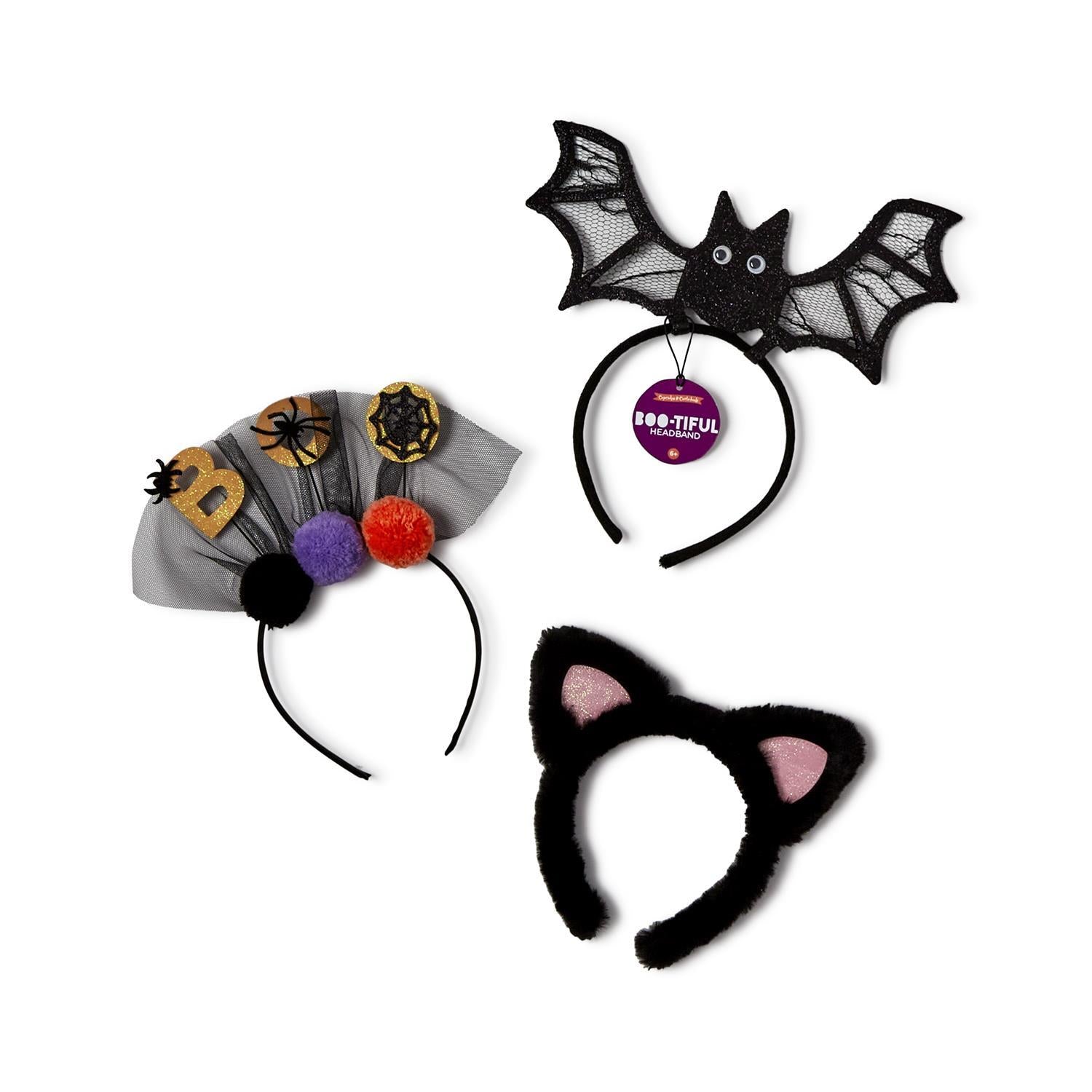 Three playful Halloween headbands featuring a bat, a cat, and a spooky design with pom-poms, perfect for parties or trick-or-treating from Cupcakes and Cartwheels. Ideal Halloween headband accessories.