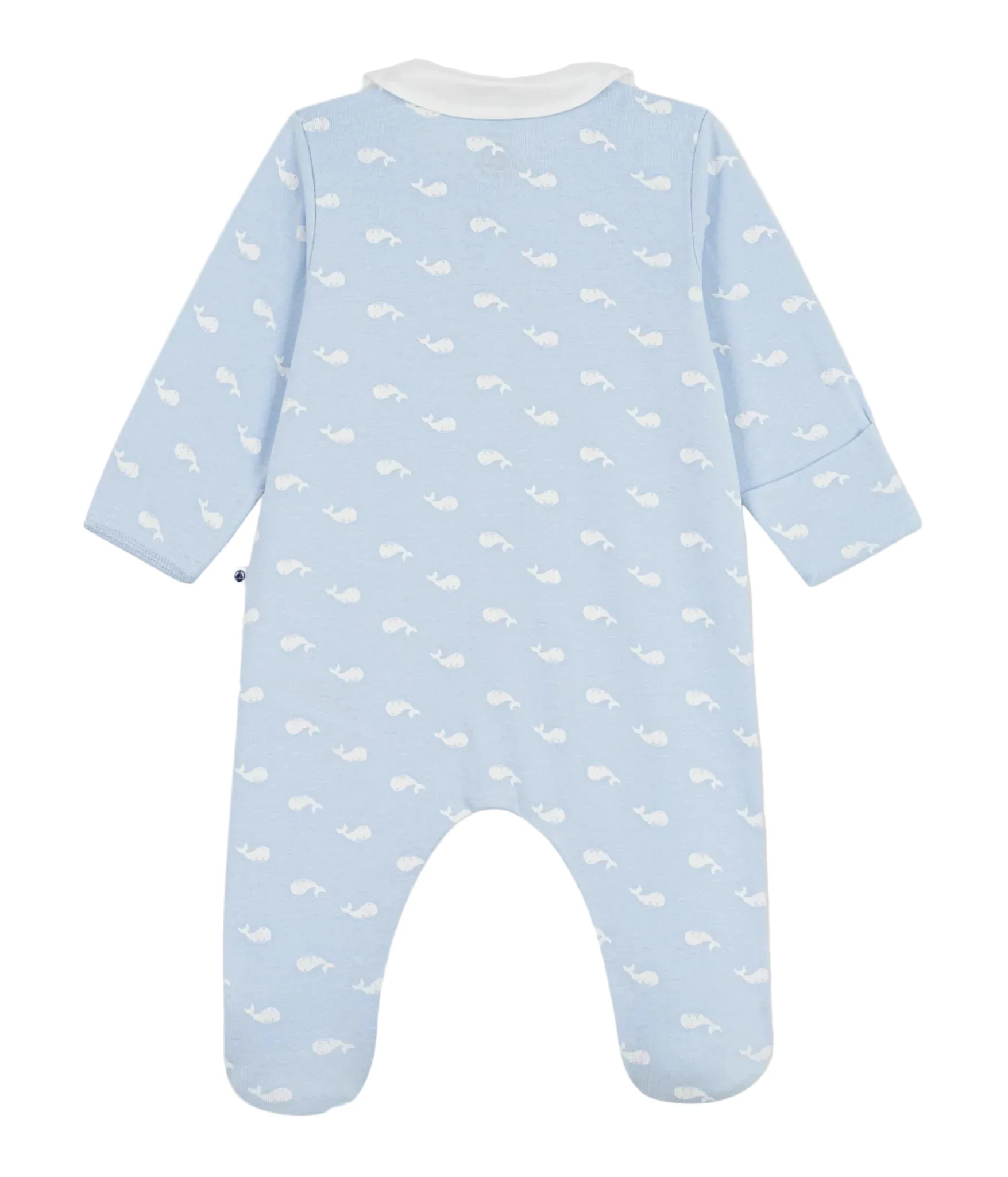 A baby footed one-piece sleeper in light blue with a white whale print, shown from the back on a light gray background.