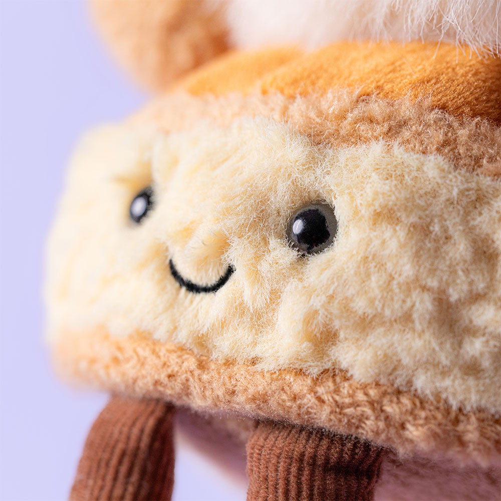 Close-up of the happy face on the Amuseables Mirielle St. Honoré plush by JellyCat, emphasizing its friendly smile and plush details.