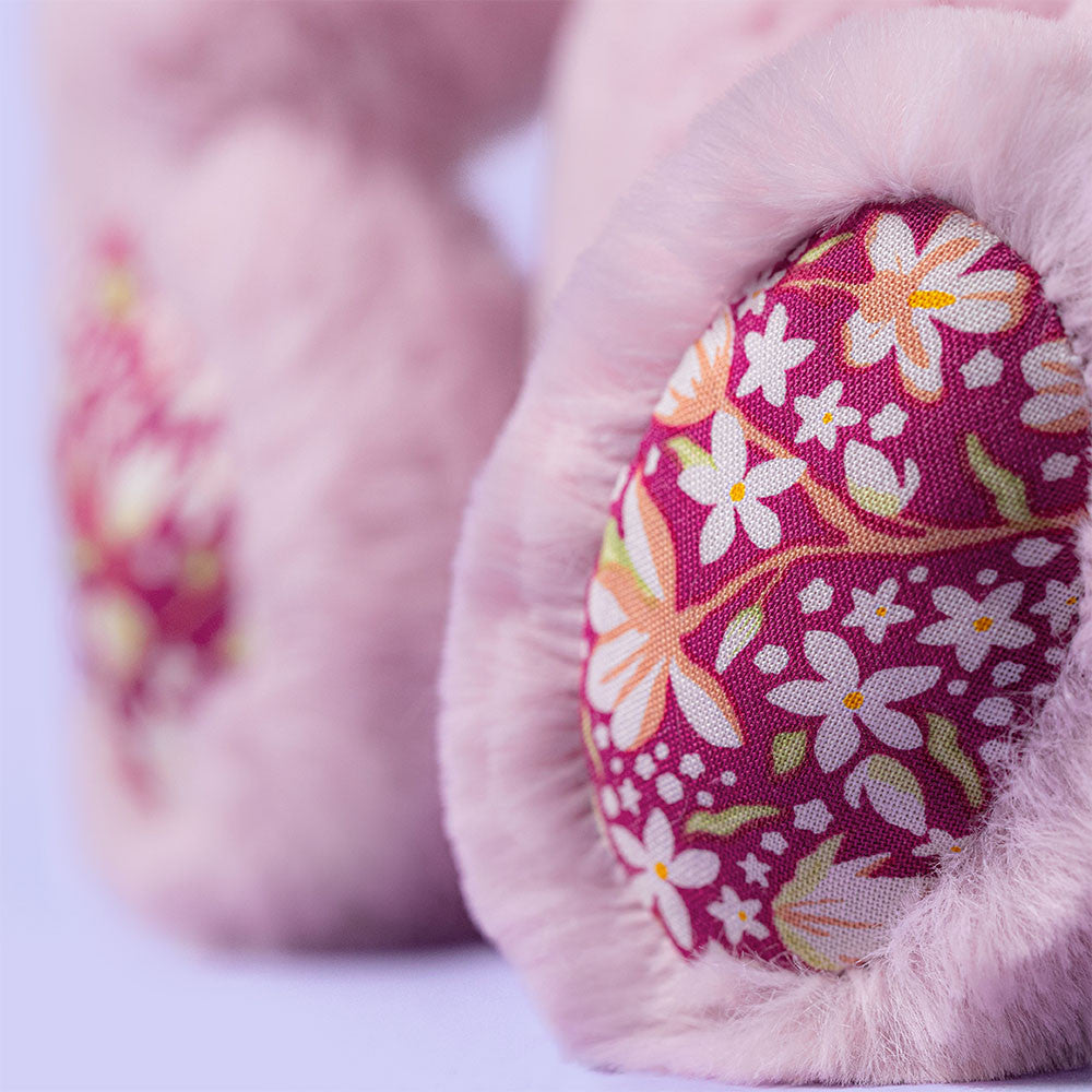 Close-up of the paws of Thistlepop Blossom Luxe Bunny by JellyCat, highlighting the pretty floral fabric on its ears.