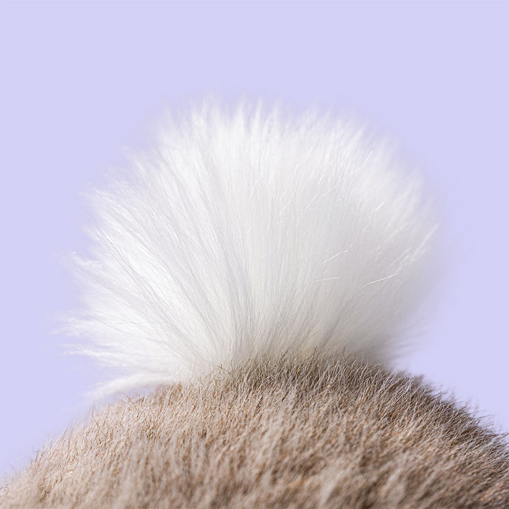 Close-up of the fluffy tail of the Fawn Flufflet Bunny by JellyCat, emphasizing its soft textures.
