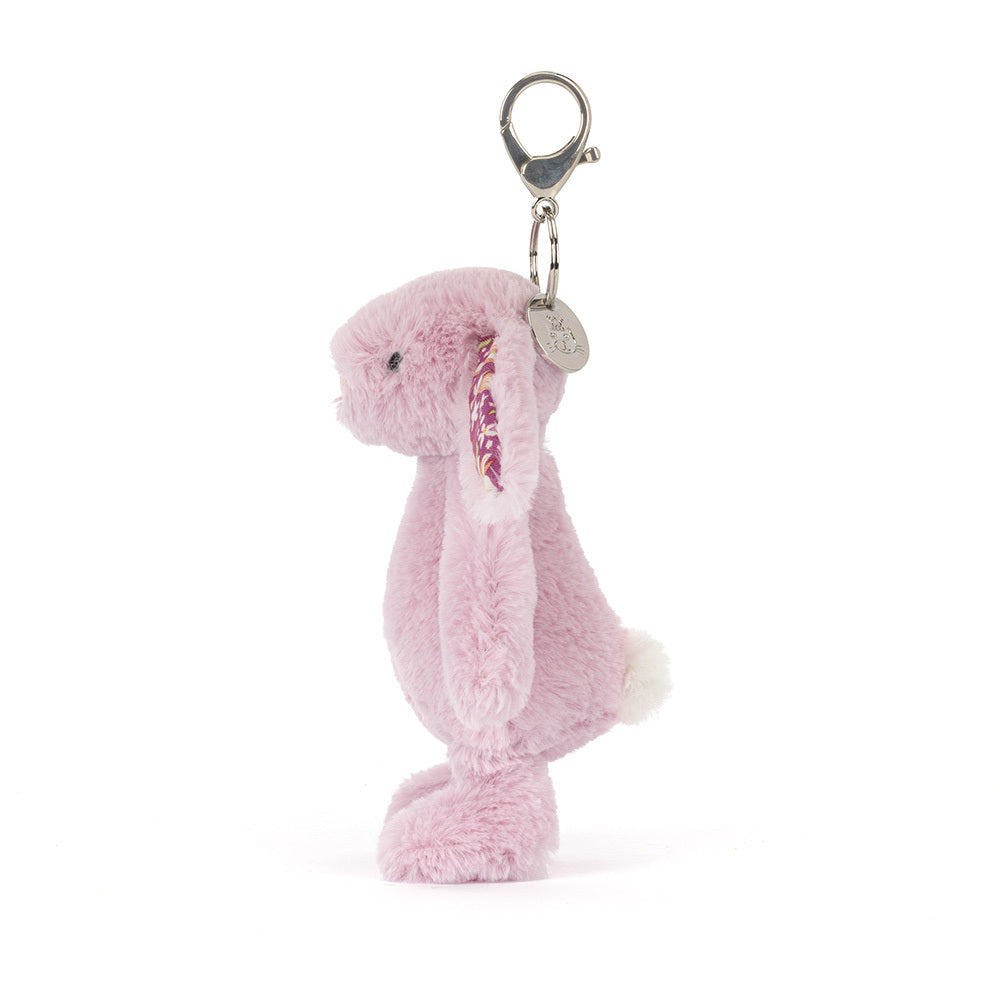 Thistlepop Blossom Bunny Bag Charm hanging from a stylish bag, adding a whimsical touch to personal accessories.