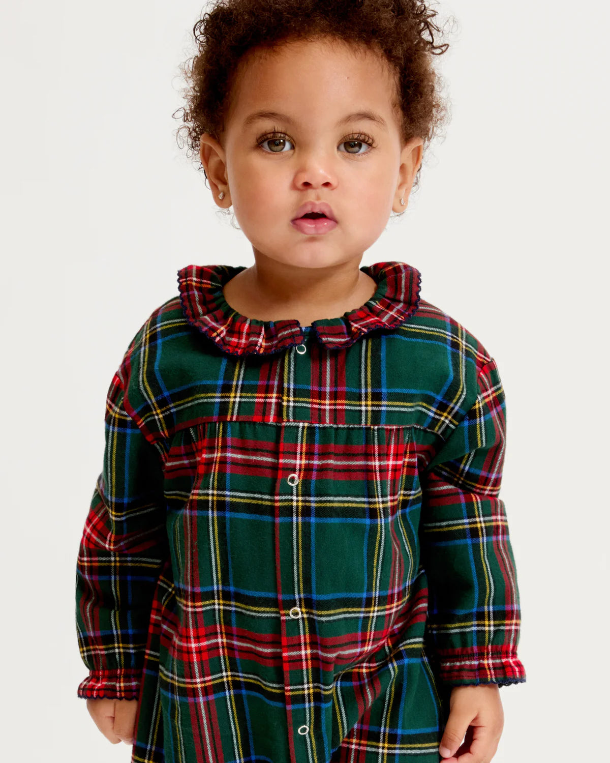 An adorable baby wearing the Baby Twill Madeline Romper Kensington Plaid, embodying comfort and style during playtime.