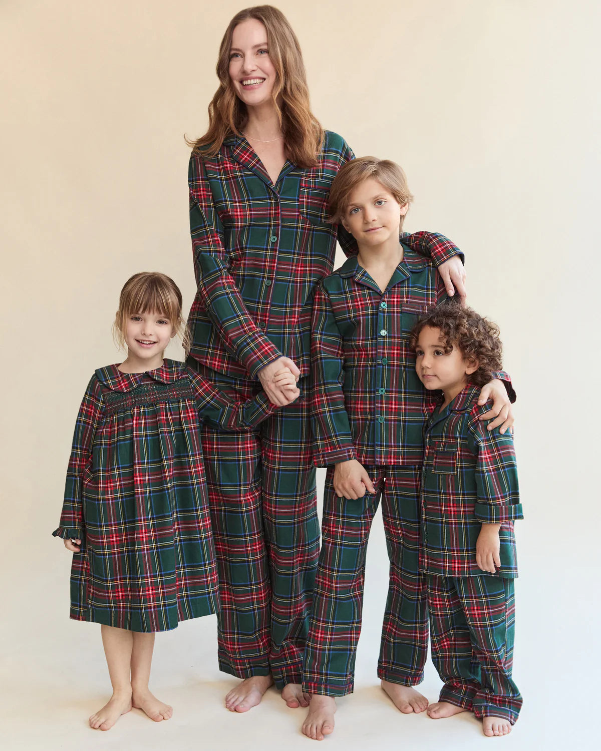 Happy child wearing Children's Brushed Twill Pajama Kensington Tartan while playing indoors.