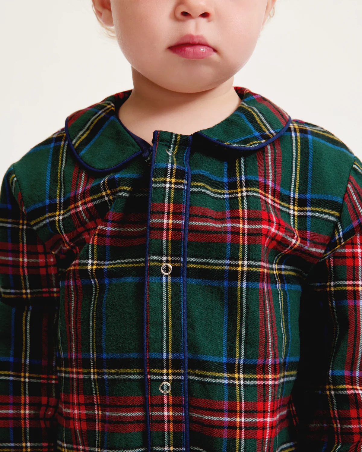 Baby Twill Cambridge Romper Kensington Plaid hanging on a clothesline, illustrating the vibrant tartan design.