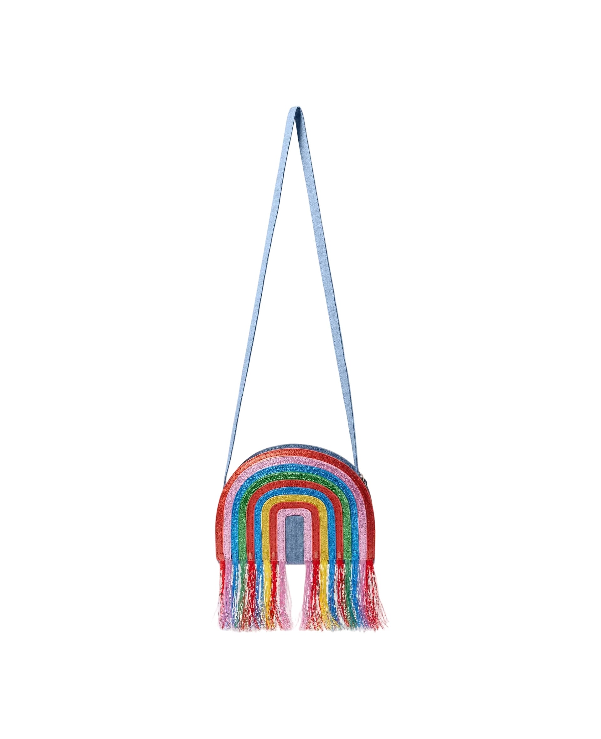 A small rainbow-shaped shoulder bag with multicolored fringe and a light blue strap, shown against a plain light gray background.