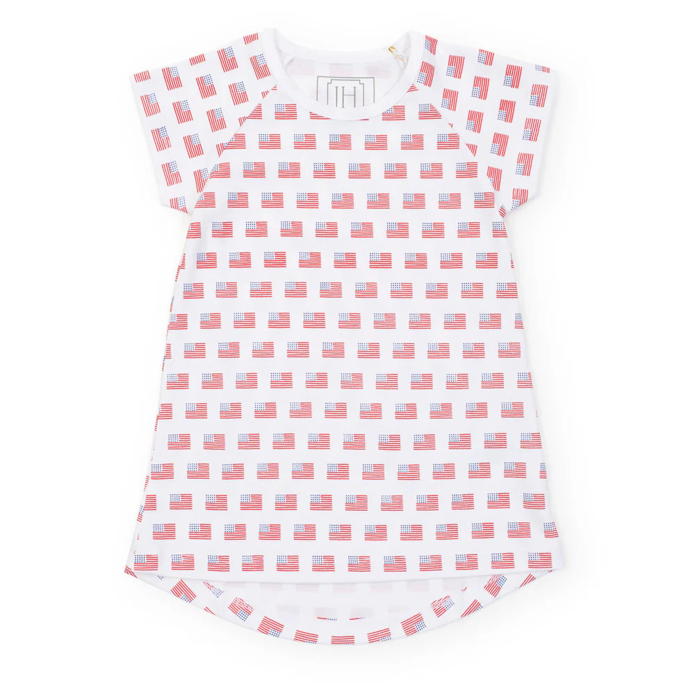 Sadie-American Flag dress by Lila and Hayes, featuring a vibrant pattern of American flags on a white background, perfect for girls' summer wear.