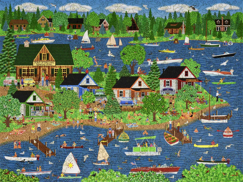 A vibrant and detailed scene of a lakeside community featuring houses, boats, and people enjoying summer activities, part of the 'Summer at the Lake' puzzle by Liberty Puzzles.