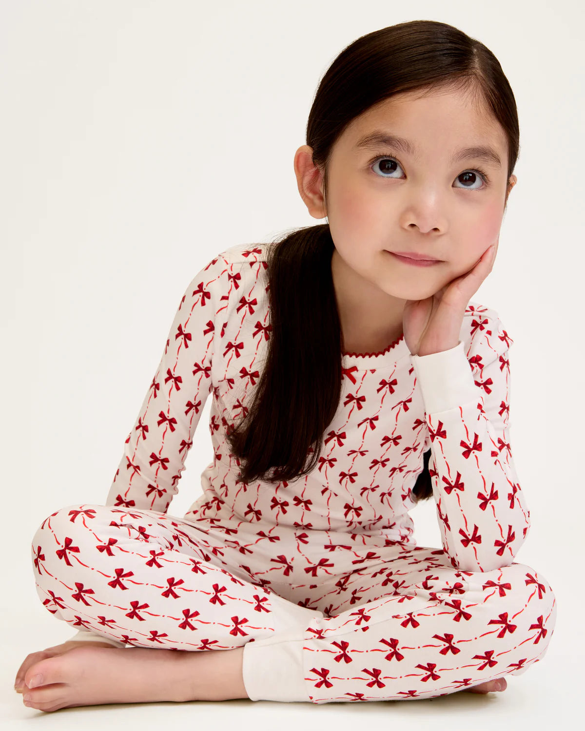 Girls Pima Snug Fit Pajama in Blissful Bows displayed on a cozy bed, emphasizing comfort and style for kids.