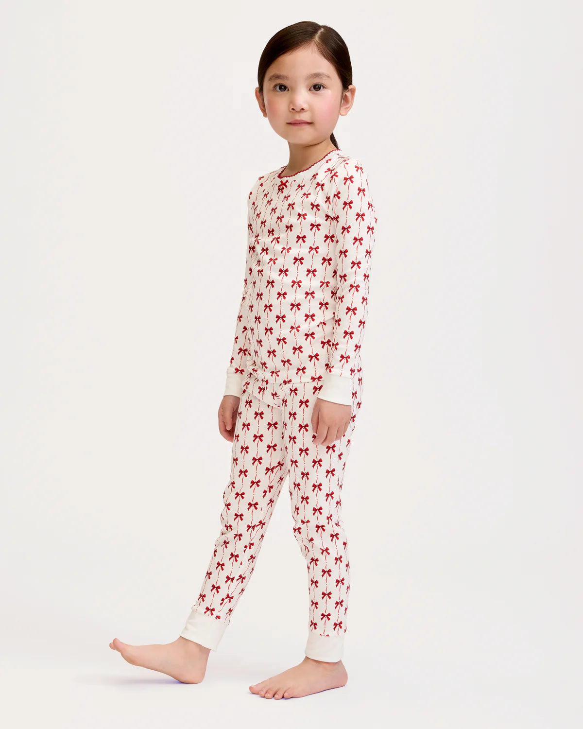 Full view of Girls Pima Snug Fit Pajama in Blissful Bows on a little girl, highlighting snug fit and playful design.