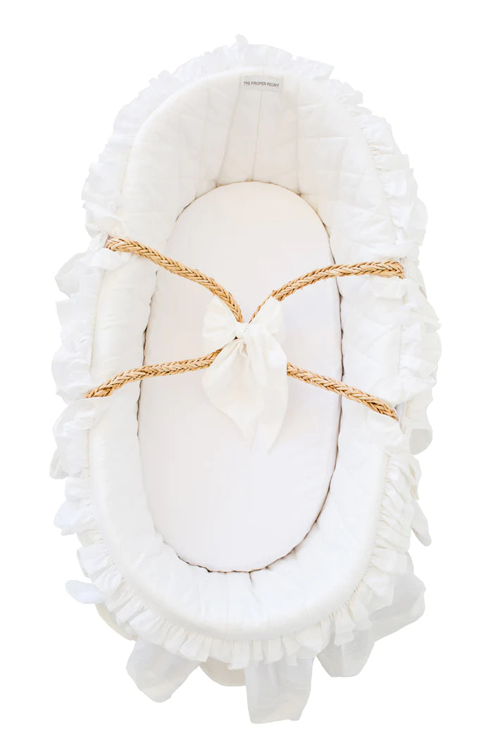 An elegant Proper Peony Moses Basket for Baby in Ecru and White, featuring 100% cotton bedding and a beautiful scalloped border. This stylish moses basket for baby by The Proper Peony is perfect for a cozy nursery setup. the-proper-peony