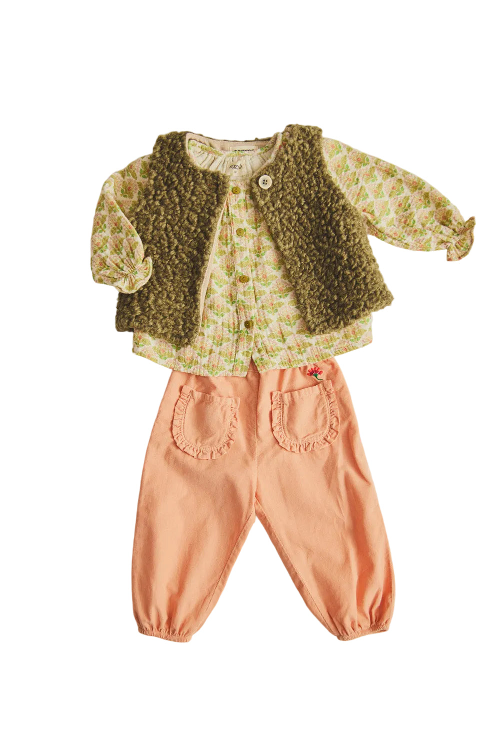 Children's outfit with floral top, green vest, and pink pants on a light background